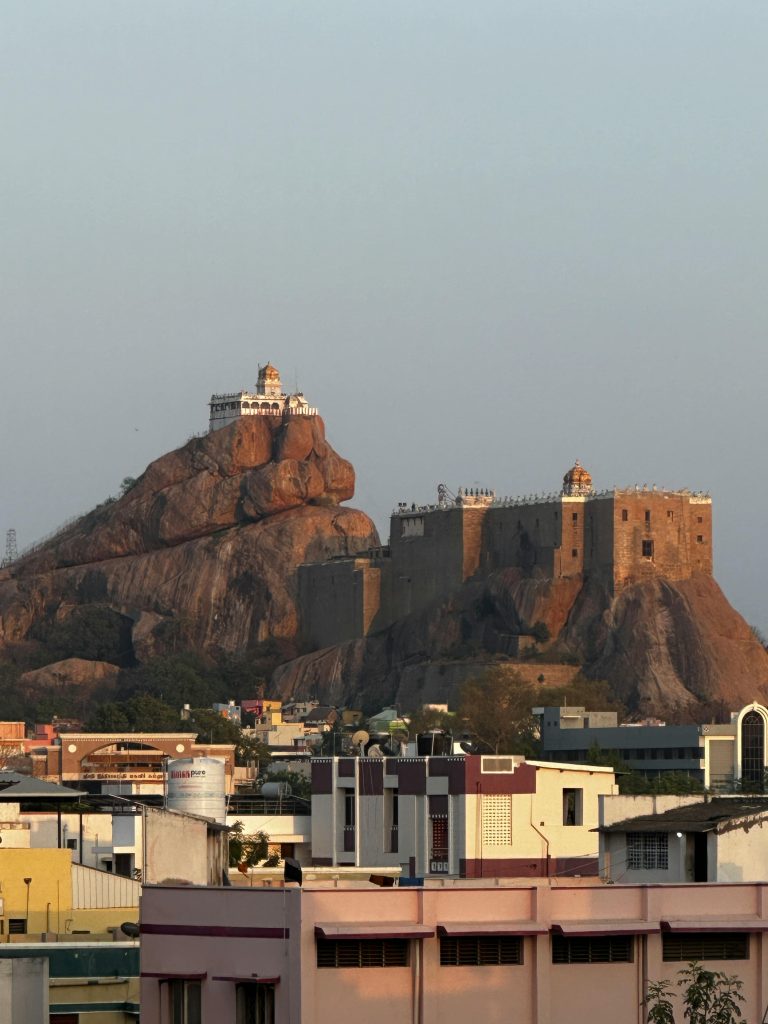 Stunning view of Rock Fort Temple and surrounding cityscape in Tiruchirappalli, India captured in daylight.